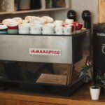 Kohi slow coffee bar interior featuring espresso machine, branded cups, and coffee packaging