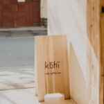Kohi slow coffee bar wooden sidewalk signage board with minimalist branding