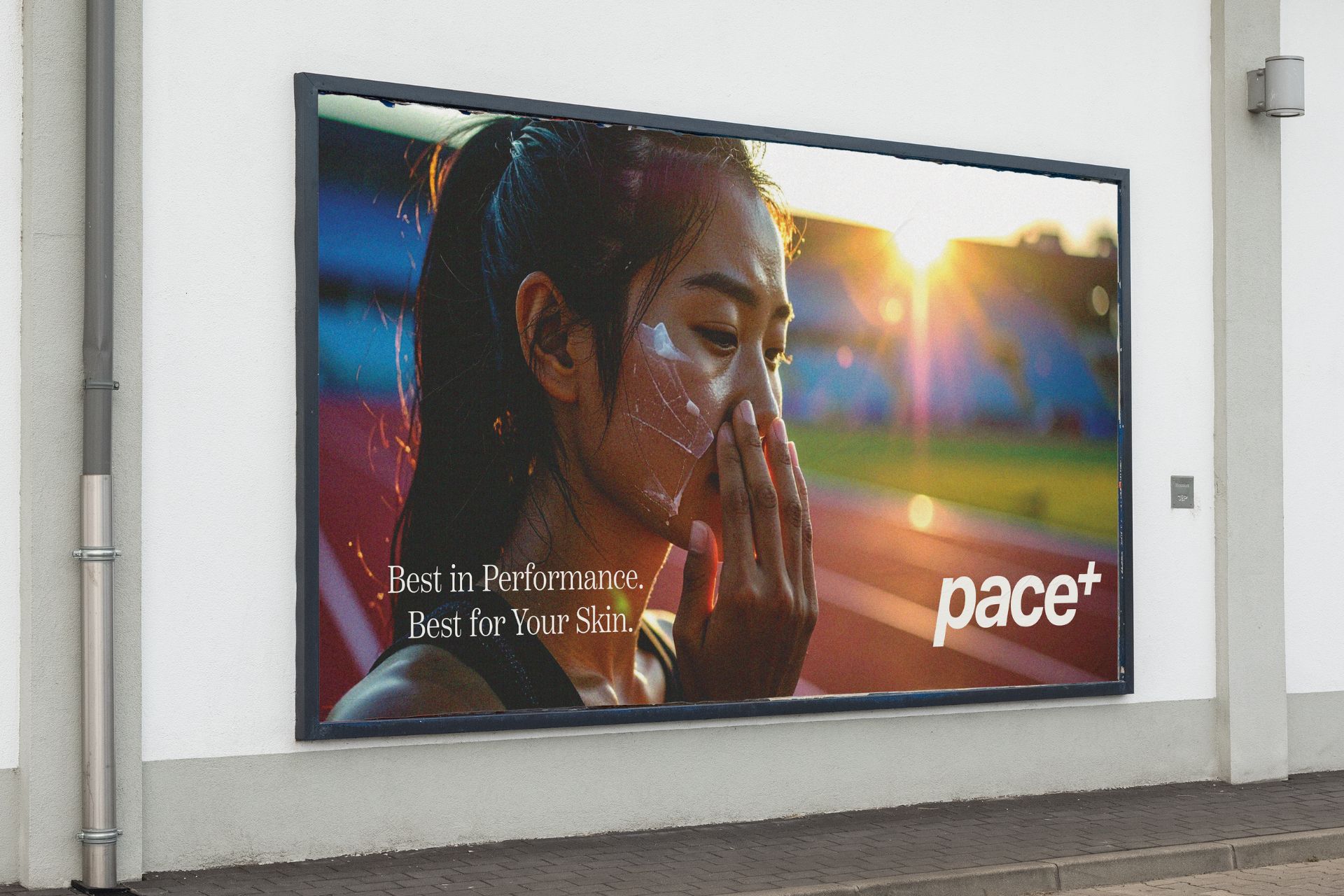Outdoor advertising campaign for Pace+ sunscreen featuring female athlete applying sport skincare product