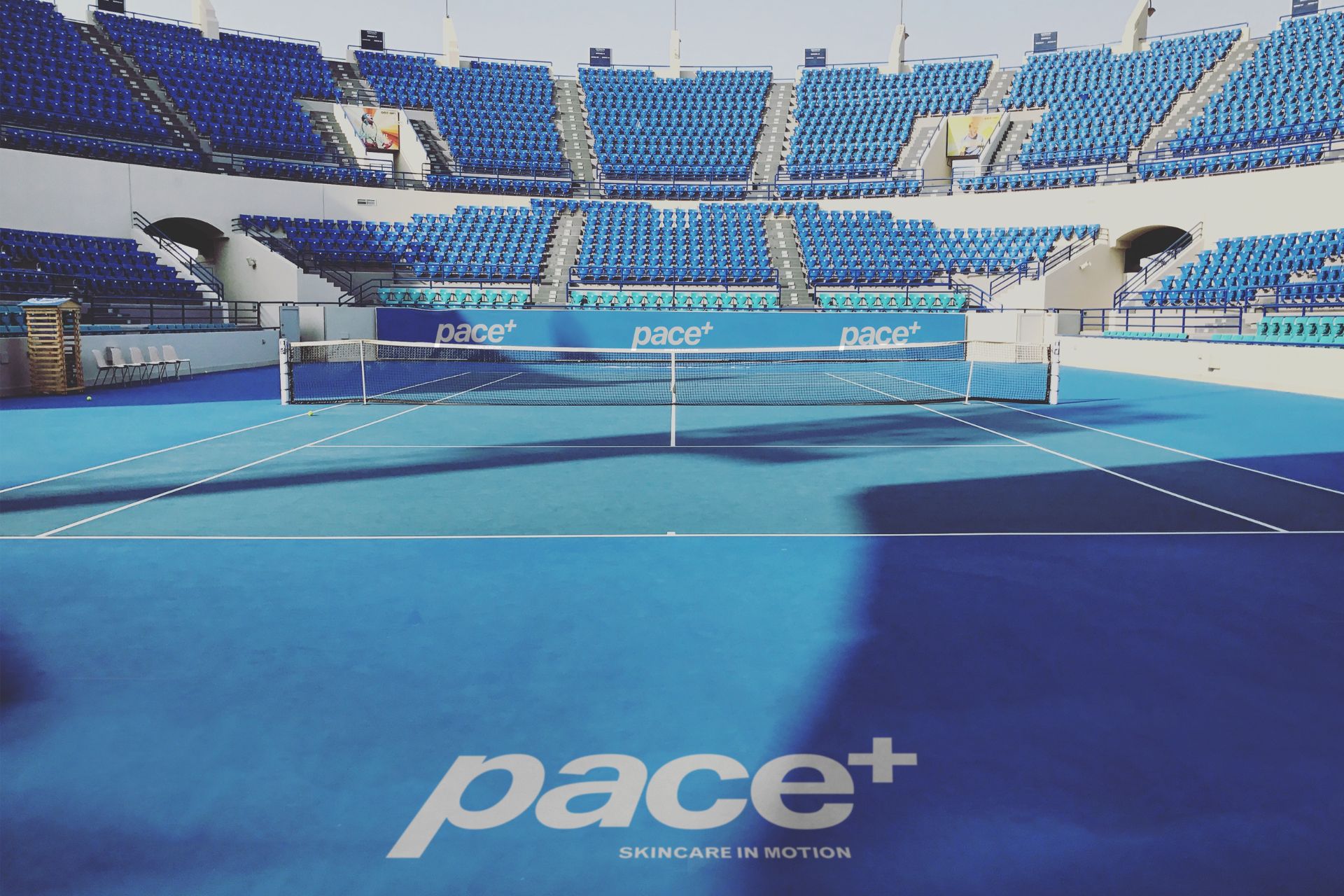 Pace+ sport skincare branding applied across professional tennis court with logo integration and stadium advertising
