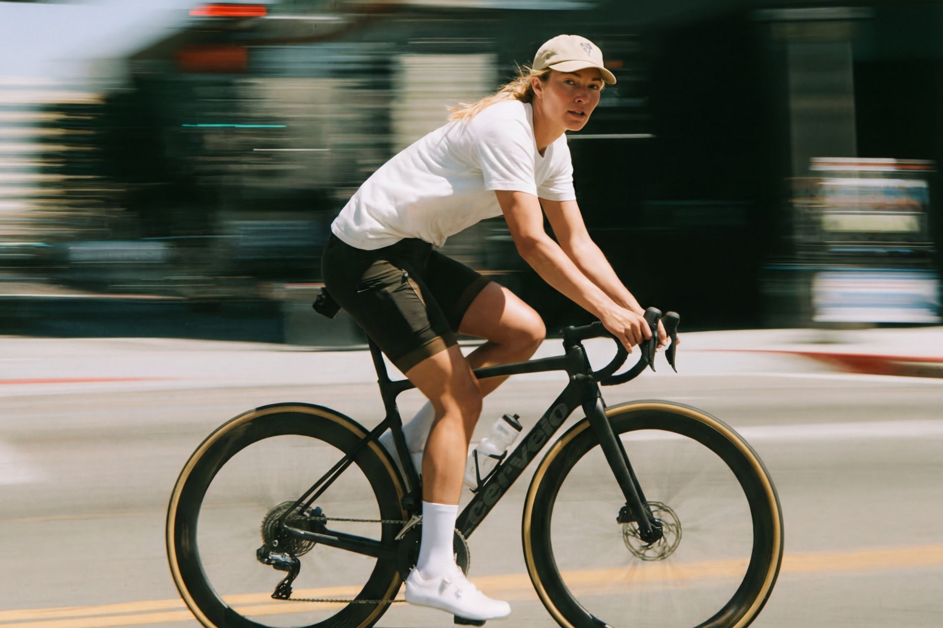 AI visual of female cyclist riding fast in city with motion blur and road bike